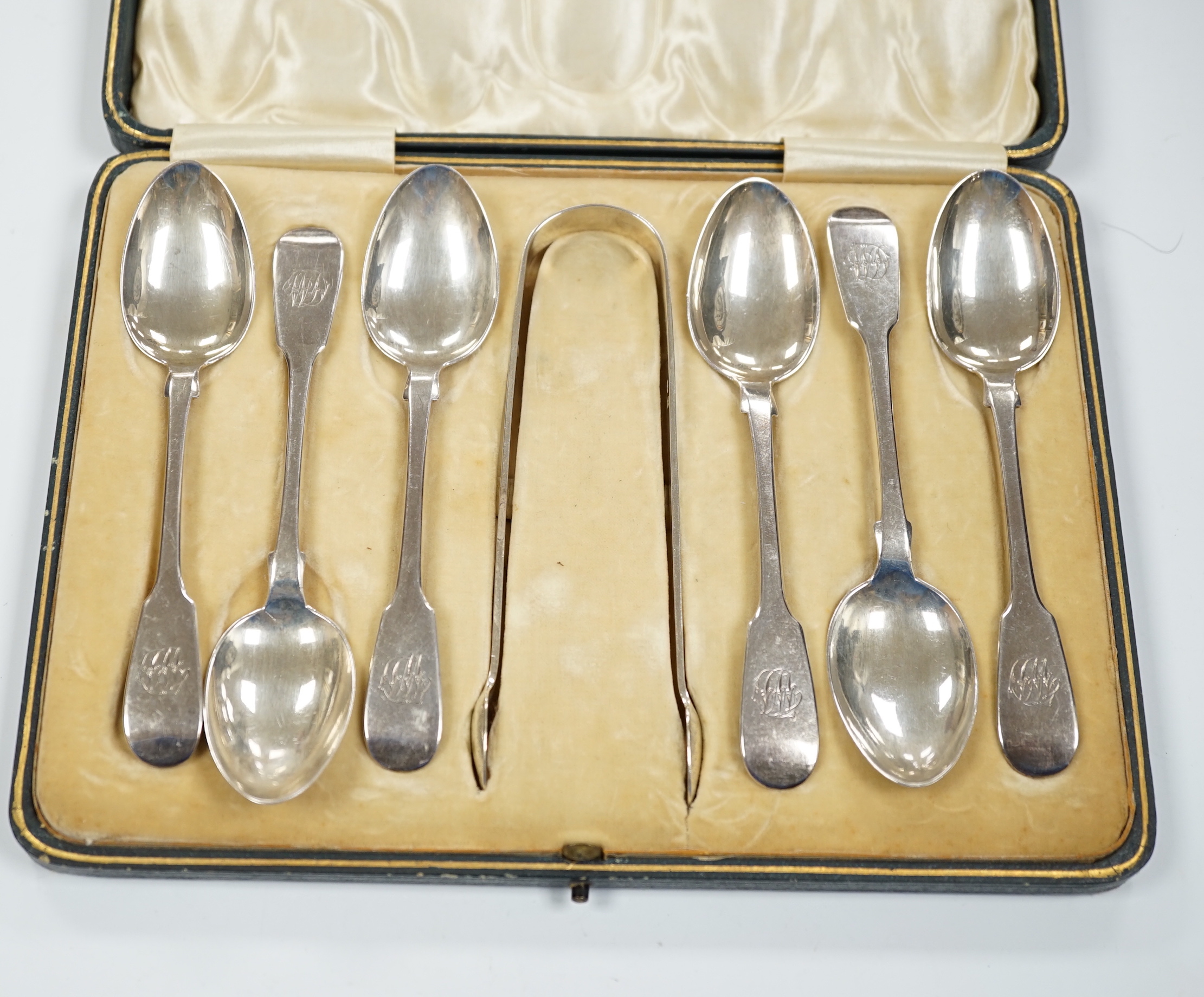 A set of six Victorian provincial silver fiddle pattern teaspoons, Reid & Sons, Newcastle, 1873 and a pair of associated silver sugar tongs, in associated case.